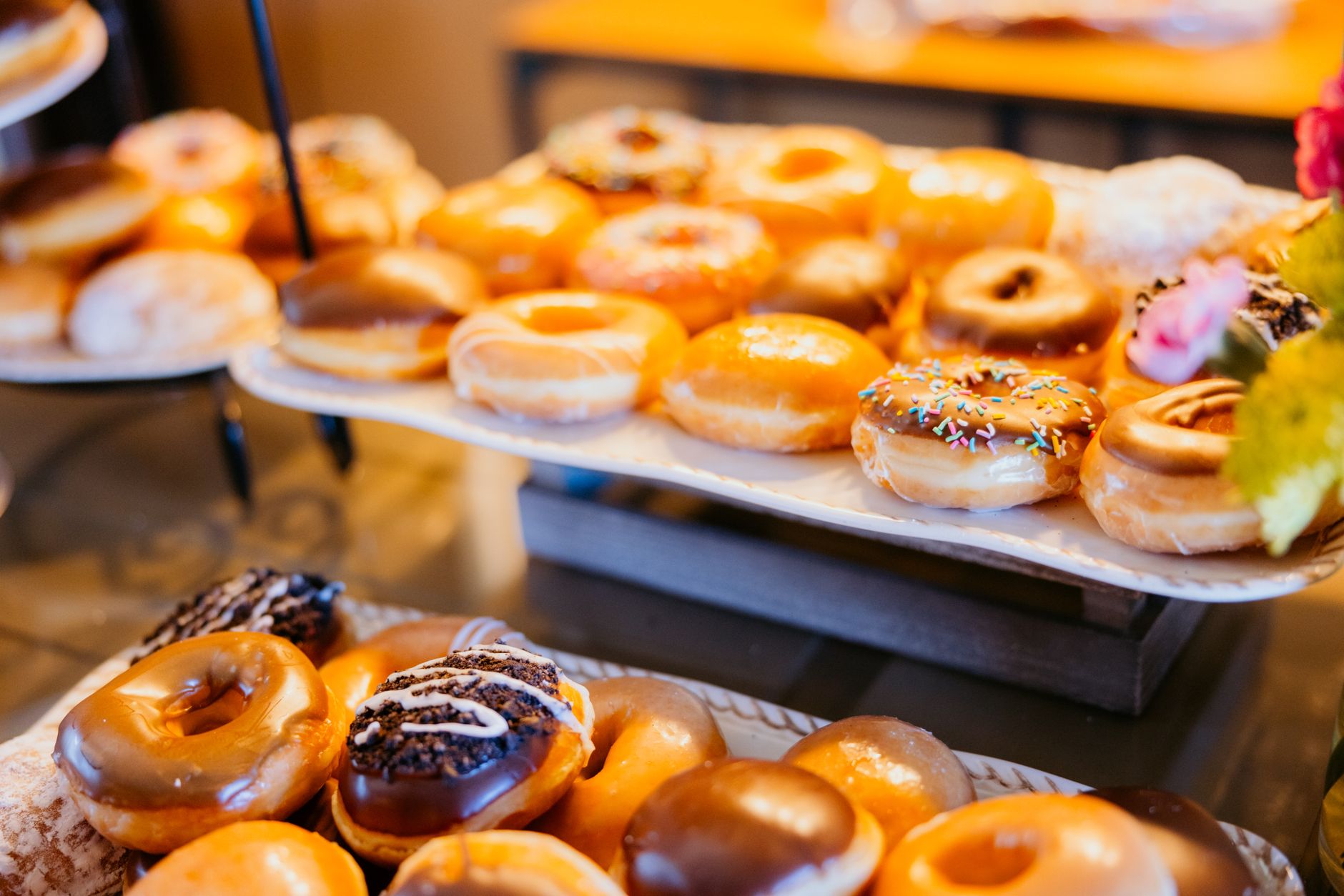 A tempting display of assorted glazed and decorated donuts on a dessert table.
