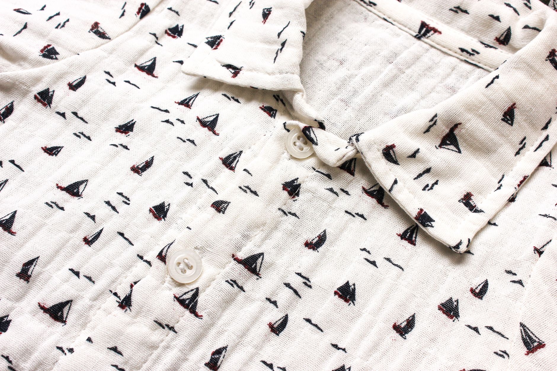 Closeup of soft muslin fabric with sailing boat pattern