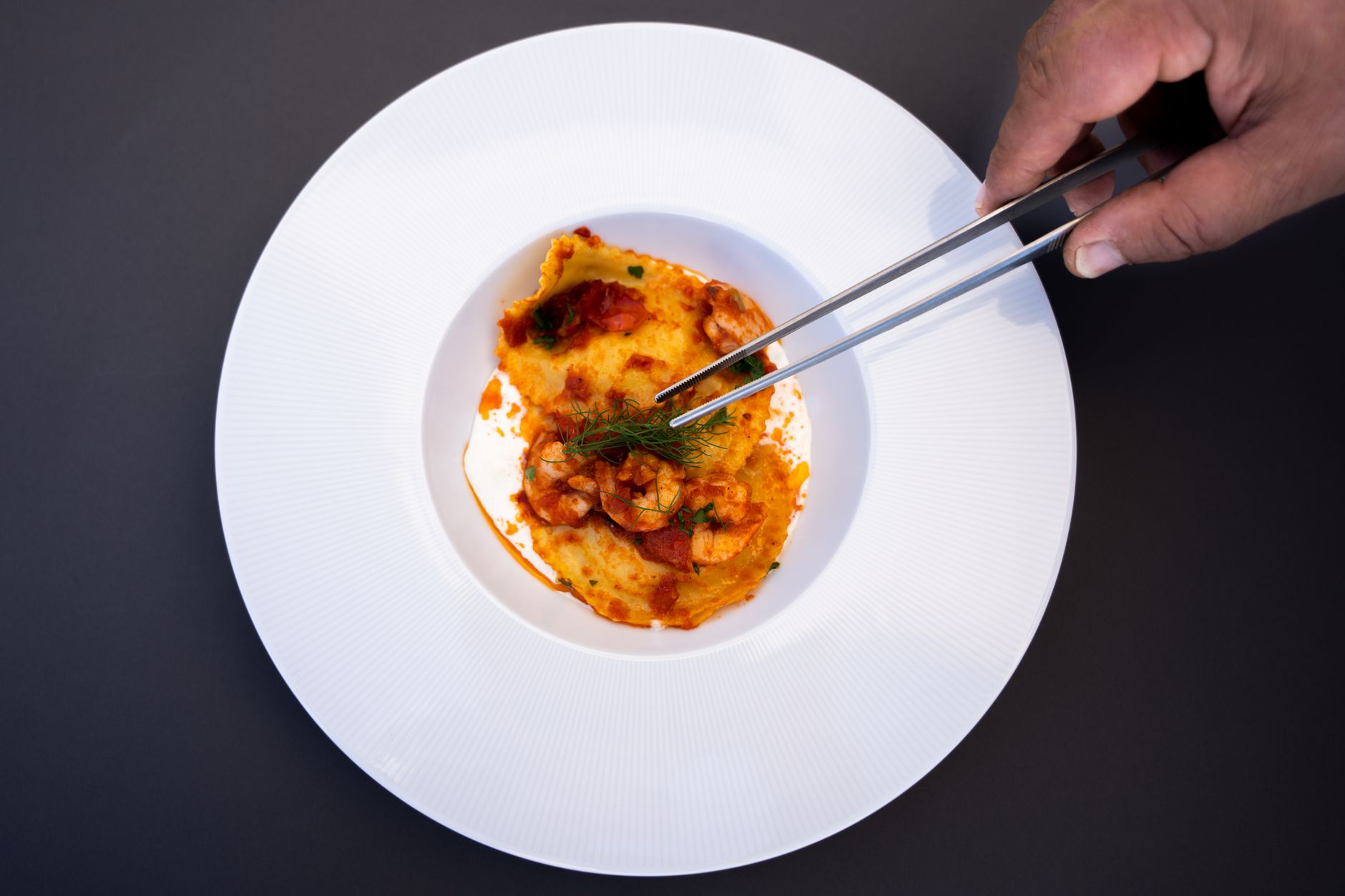 Delicious seafood ravioli meticulously styled in a white bowl, captured with culinary precision.