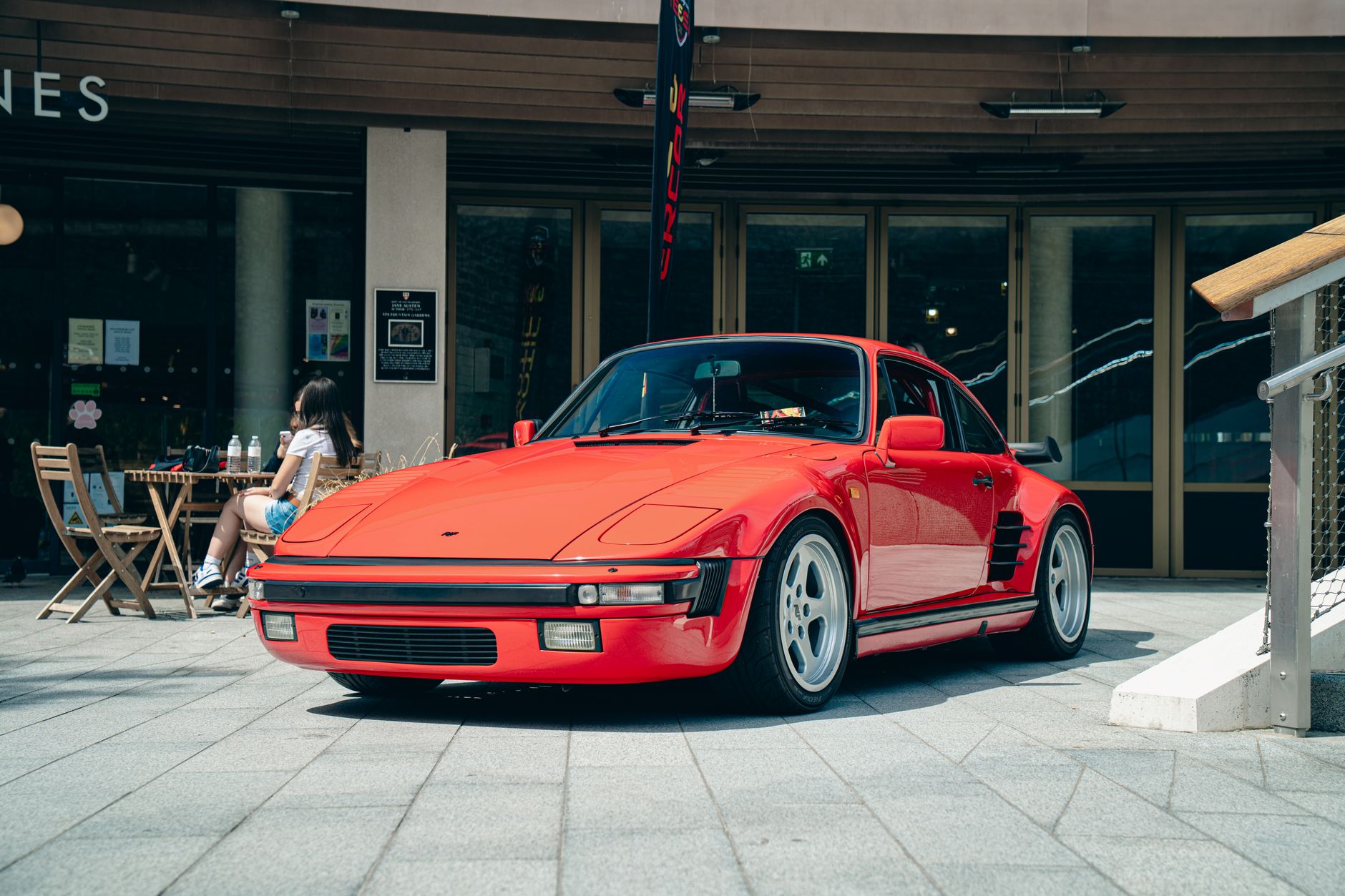Classic red Porsche 911 sports car parked outdoors.